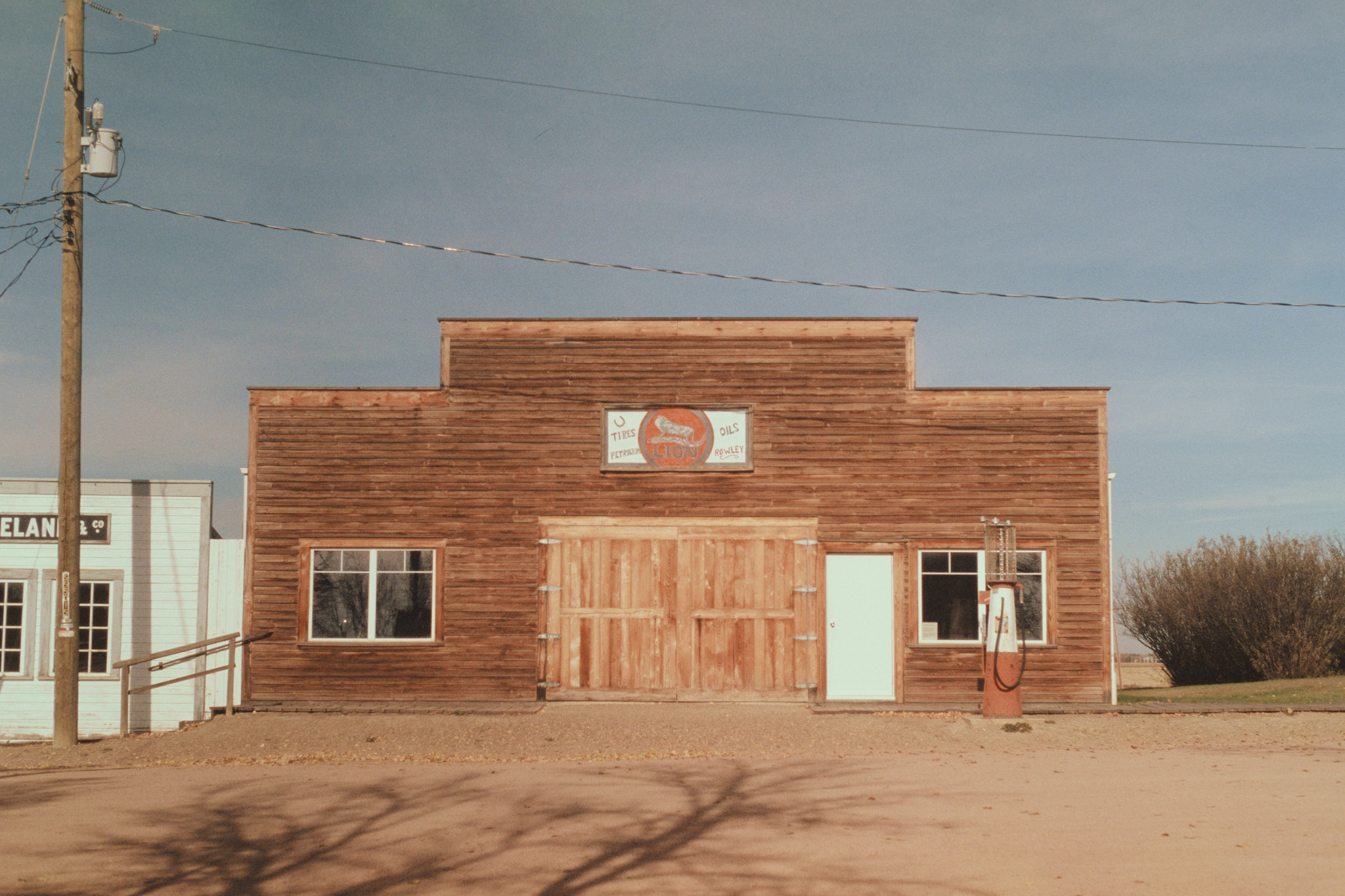 Heritage building with vintage gas pump in Rowley Alberta, medium format film