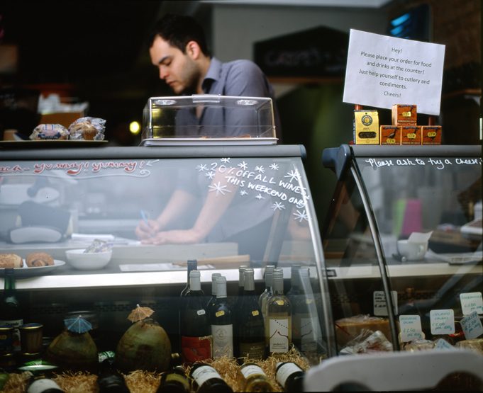 Deli counter with artisan food and wine — commercial lifestyle photography